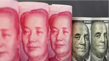  ?? — Reuters ?? Keeping it steady: The People’s Bank of China set the daily reference rate around 7.073 per dollar for a fifteenth straight trading day yesterday, pushing the fixing’s 10-day volatility to the lowest since January 2011.