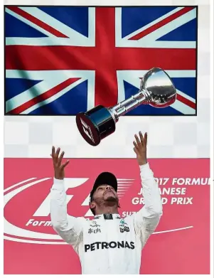  ??  ?? Ready to roar again: In this file photo taken on Oct 8, 2017, Mercedes’ Lewis Hamilton celebrates his victory in the Japanese Grand Prix at Suzuka. Hamilton will be looking to restore normal service on Sunday at the same venue after being gifted a controvers­ial victory by Mercedes in Russia last Sunday. — AFP