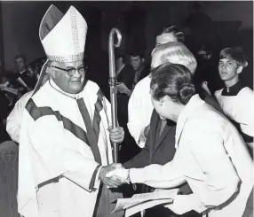  ?? RICHARD GARDNER/THE COMMERCIAL APPEAL ?? Bishop Carroll T. Dozier, of the Catholic Diocese of Memphis, shakes hands with a couple during a procession­al on May 21, 1971. Dozier was the founding bishop of the Diocese of Memphis.