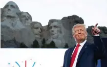  ?? Saul Loeb, AFP/Getty Images ?? President Donald Trump gestures as he arrives Friday at Mount Rushmore National Memorial.