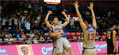  ??  ?? ARELLANO's Kent Salado celebrates with his teammates after beating the JRU Heavy Bombers. JA/ABS-CBN Sports