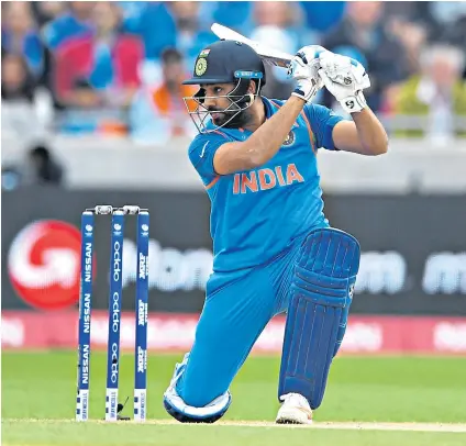  ??  ?? Masterclas­s: Rohit Sharma drives to the cover boundary during his match-winning century in the semi-final