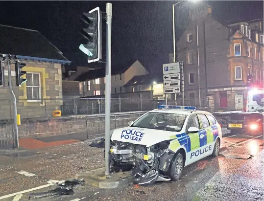  ??  ?? The badly damaged police car at the scene of the crash near Perth Police Station.