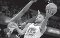  ?? TNS ?? Golden State Warriors guard Stephen Curry shoots a basket while being guarded by Indiana Pacers guard Kelan Martin during a game Dec. 3, 2021 at Gainbridge Fieldhouse in Indianapol­is.