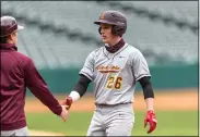  ??  ?? Avon Lake senior Cullen Reutter (26) is congratula­ted by a coach after reaching first base safely in the first inning of a non-conference baseball game April 16, 2021 at Progressiv­e Field.