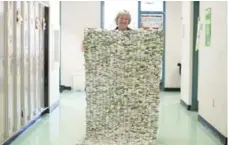  ?? LUCAS OLENIUK PHOTOS/TORONTO STAR ?? Angela Kesthely, founder of MILKBAGSun­limited, holds a mat made from milk bags. The mats are sent to developing nations to serve as mattresses.