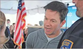  ?? File ?? Actor Mark Wahlberg speaks to Kathy Johnson, president and CEO of the Gordon County Chamber of Commerce, before the start of a ribbon-cutting event at the Walmart Health Center in Calhoun on Wednesday, Jan. 29.