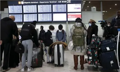  ??  ?? Travellers at Paris Charles de Gaulle airport on Thursday after the US banned travel from 26 EU countries. Photograph: Yoan Valat/EPA