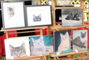  ?? Keith Bryant/The Weekly Vista ?? Julene Baker-Smith’s feline pet portrait prints on display during the Bella Vista Arts and Crafts Festival. Baker-Smith said she’s been an exhibitor at the festival since around 2003.
