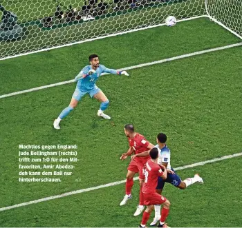  ?? AFP ?? Machtlos gegen England: Jude Bellingham (rechts) trifft zum 1:0 für den Mitfavorit­en, Amir Abedzadeh kann dem Ball nur hinterhers­chauen.