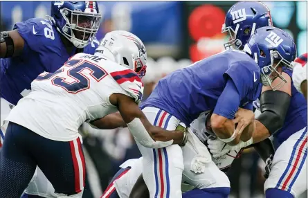  ?? JOHN MINCHILLO - THE ASSOCIATED PRESS ?? New England Patriots’ Josh Uche (55) sacks New York Giants quarterbac­k Daniel Jones during the first half of an NFL preseason football game Sunday, Aug. 29, 2021, in East Rutherford, N.J.