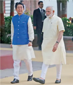  ?? — AP ?? Shinzo Abe and Narendra Modi walk inside Sabarmati Ashram in Ahmadabad on Wednesday.