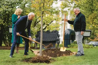  ?? EVAN VUCCI/AP 2022 ?? President Joe Biden, center, first lady Jill Biden and Dale Haney, the chief White House groundskee­per, take part in a tree-planting ceremony last fall on the South Lawn of the White House. Trees are not reliable carbon sinks, writes Bloomberg’s Mark Gongloff.