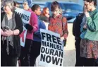  ?? APPEAL ?? Community members attend an April 10 vigil outside El Mercadito de Memphis in Hickory Hill to support Manuel Duran. The reporter for Spanish-language media was arrested April 3 while doing a live Internet video of a Memphis protest. Duran has since...