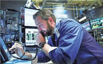  ?? SPENCER PLATT, GETTY IMAGES ?? A trader works at the New York Stock Exchange. In three weeks, the Dow has gained 6%.