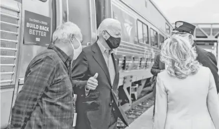  ?? ANDREW HARNIK/AP ?? Democratic presidenti­al nominee Joe Biden gives a thumbs up after speaking to supporters before boarding his train with his wife Jill Biden, right, at Amtrak’s Cleveland Lakefront train station on Wednesday.