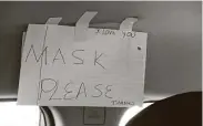  ?? Lea Suzuki / San Francisco Chronicle ?? A sign posted in Rosa Mendoza’s car asks passengers to wear protective face masks in San Francisco.