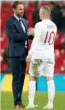  ?? — AFP ?? England striker Wayne Rooney is greeted by England’s manager Gareth Southgate during the internatio­nal friendly match between England and the US in London on Thursday.