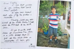  ??  ?? LETTER FROM 'GEORGE' A handout photo from Compassion Internatio­nal shows young Filipino boy Timothy and a letter to him from 'George Walker', who the Christian charity group said was actually US President George Walker Bush. See another letter on Page 8. (EPA-EFE)