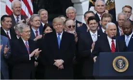  ?? Photograph: Manuel Balce Ceneta/AP ?? Republican lawmakers celebrate the passage of their tax bill at the White House with Donald Trump and Mike Pence on 20 December 2017.