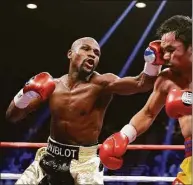  ?? Isaac Brekken / Associated Press ?? Floyd Mayweather Jr., left, will be inducted into the Boxing Hall of Fame in Canastota, N.Y., on Sunday.