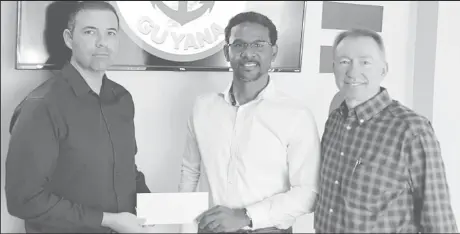  ??  ?? YBG Co-Director Rayad Boyce [center] receives the sponsorshi­p cheque from Daniel LaFont [left], the Business Developmen­t Director. Also in the photo is Country Manager Cory Jarreau.