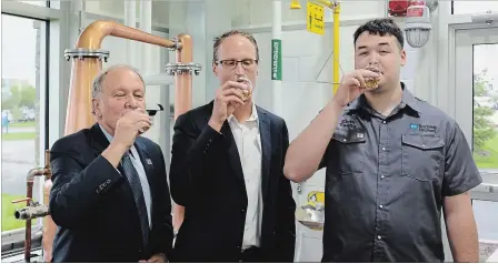  ?? DAVE JOHNSON THE WELLAND TRIBUNE ?? Niagara College president Dan Patterson, from left, Hiram Walker master blender Don Livermore and student Kirin Tsang share a toast at the opening of the college’s teaching distillery at the Niagara-on-the-Lake campus.