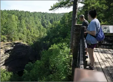  ?? (Arkansas Democrat-Gazette/Stephen Swofford) ?? Jessica Hamilton (right) and Mark Sustaita admire Cedar Falls from the overlook trail as they explore Petit Jean State Park on Aug. 4.