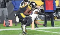  ?? Don Wright / Associated Press ?? Pittsburgh Steelers wide receiver JuJu Smith-Schuster catches a pass for a touchdown as Baltimore Ravens cornerback Tramon Williams defends during the second half Wednesday in Pittsburgh.