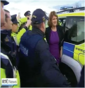  ??  ?? whisked away: The Tánaiste is escorted from the scene by gardaí