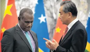  ?? PHOTO: AP ?? In discussion . . . Solomon Islands Foreign Minister Jeremiah Manele (left) and Chinese Foreign Minister Wang Yi talk during a 2019 meeting in Beijing.