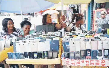  ??  ?? File photo shows women vendors display Nokia phone models for sale along with smartphone­s at the ‘Computer Village’ in Ikeja district in Nigeria’s commercial capital Lagos, Nigeria May 31. Nokia’s new products, which grew out of its 15.6 billion-euro...