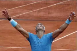  ?? Associated Press ?? Rafael Nadal celebrates his 11th French Open title in 2018. This year’s tournament had been scheduled to conclude this weekend.