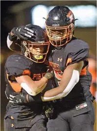  ?? STAFF PHOTO BY ROBIN RUDD ?? South Pittsburg’s De’Andre Kelly, left, and Gio Davis celebrate a touchdown by Kelly during Friday night’s TSSAA Class 1A quarterfin­al against visiting Gordonsvil­le.