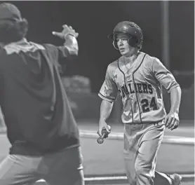  ?? JOHN GUTIERREZ/SPECIAL TO AMERICAN-STATESMAN ?? Lake Travis’ Reid Kilgo returns to the dugout after a run scored to finalize the Cavs’ 4-1 win against the San Marcos Rattlers in the area-round baseball playoffs last season at Dripping Springs High School.