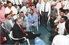  ?? Ahmed Kutty/Gulf News ?? Ambassador Navdeep Singh Suri interacts with workers during a visit to a labour accommodat­ion in Mussaffah.