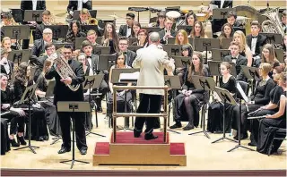  ??  ?? Sean O’Neill conducting rehearsals at Carnegie Hall with internatio­nal euphonium virtuoso David Childs. Below, on stage with Sean O’Neill