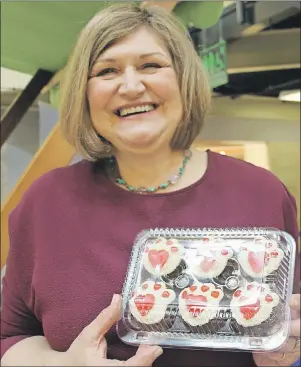  ?? LETRE SWEETING/TC MEDIA ?? Elaine Gascon, a volunteer for the P.E.I. Humane Society, sells cupcakes at the Confederat­ion Court Mall in Charlottet­own as part of National Cupcake Day, Monday, to raise money to support abused and neglected animals.