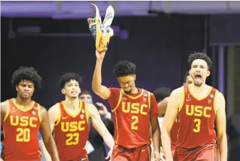  ?? Andy Lyons / Getty Images ?? USC’s Ethan Anderson (20), Max Agbonkpolo (23), Tahj Eaddy (2) and Isaiah Mobley are enthused as the Trojans rolled over Kansas by 34 points to reach the Sweet 16.