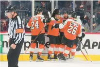 ?? MITCHELL LEFF/GETTY ?? The Flyers’ Travis Konecny, center, celebrates with Nick Seeler, from left, Joel Farabee and Sean Walker after scoring a goal against the Winnipeg Jets in the first period Thursday at the Wells Fargo Center in Philadelph­ia.