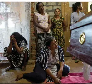  ?? AP/GEMUNU AMARASINGH­E ?? Relatives weep Monday near the coffin of 11-year-old Sneha Savindi Fernando, who was a victim of an Easter Sunday bombing at St. Sebastian Church in Negombo, Sri Lanka.