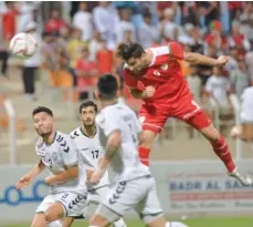  ?? — Faisal al Balushi ?? Abdulaziz al Muqbali scores a goal for Oman.
