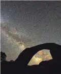  ?? TREVOR HUGHES/USA TODAY ?? The rising Milky Way shines through Rainbow Bridge near Lake Powell on the Utah-Arizona border.