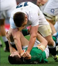  ??  ?? TOUGHING IT
OUT: Garry Ringrose (main) is tackled by England’s Jonathan Joseph and Joe Launchbury; Owen Farrell gets to grips with Johnny Sexton (left) as Ireland’s Dan Leavy (above) greets the final whistle