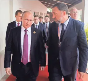  ??  ?? Russian President Vladimir Putin, left, and oligarch Oleg Deripaska arrive at a forum last year. Deripaska is under new U.S. sanctions.