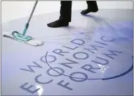  ?? THE ASSOCIATED PRESS ?? A woman cleans the stage prior to a panel session on the closing day of the 47th annual meeting of the World Economic Forum, WEF, in Davos, Switzerlan­d on Friday.