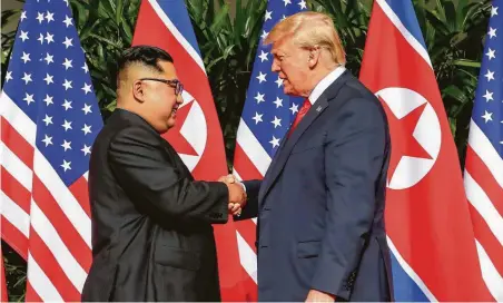  ?? Evan Vucci / Associated Press ?? President Donald Trump greets North Korean leader Kim Jong Un in a carefully choreograp­hed meeting in Singapore on Tuesday.