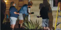  ?? PHOTO BY DYLAN BOUSCHER ?? San Jose Mayor Sam Liccardo washes spray-painted messages off the exterior of his house with the help of neighbors in San Jose on Friday.