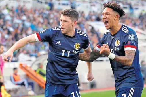  ??  ?? HIGHLAND LADDIE: Celtic’s Ryan Christie, left, celebrates scoring his first Scotland goal with Liam Palmer in Nicosia, Cyprus, on Saturday