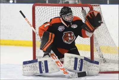  ?? NEWS PHOTO RYAN MCCRACKEN ?? South East Athletic Club Tigers goaltender Nate Hoffman flashes the leather for a glove save during Saturday’s Alberta Minor Midget Hockey League game against the Red Deer Northstar Chiefs at the Hockey Hounds Arena. The Tigers lost 8-0.